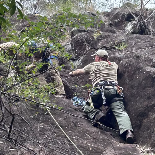 search and rescue trackers ascend mountain