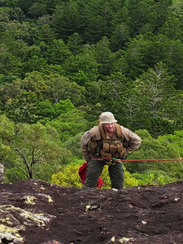 QRAT member rappelling down mountain
